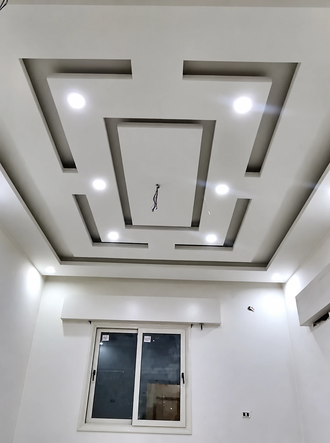 White geometric recessed ceiling with downlights
